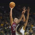 
              South Dakota center Hannah Sjerven, left, shoots against Baylor center Queen Egbo during the first half of a college basketball game in the second round of the NCAA tournament in Waco, Texas, Sunday, March 20, 2022. (AP Photo/LM Otero)
            