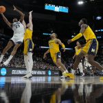 
              Villanova forward Jermaine Samuels shoots over Michigan center Hunter Dickinson during the first half of a college basketball game in the Sweet 16 round of the NCAA tournament on Thursday, March 24, 2022, in San Antonio. (AP Photo/David J. Phillip)
            