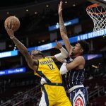 
              Indiana Pacers' Oshae Brissett (12) goes up for a shot as Houston Rockets' Christian Wood defends during the first half of an NBA basketball game Friday, March 18, 2022, in Houston. (AP Photo/David J. Phillip)
            