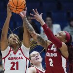 
              Georgia's Reigan Richardson (21) and Alabama's JaMya Mingo-Young (2) reach for a rebound in the first half of an NCAA college basketball game at the women's Southeastern Conference tournament Thursday, March 3, 2022, in Nashville, Tenn. (AP Photo/Mark Humphrey)
            