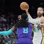 
              New Orleans Pelicans center Jonas Valanciunas, right, looks to pass around Charlotte Hornets center Montrezl Harrell (8) during the first half of an NBA basketball game on Monday, March 21, 2022, in Charlotte, N.C. (AP Photo/Rusty Jones)
            