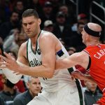 
              Milwaukee Bucks' Brook Lopez tries to get past Chicago Bulls' Alex Caruso during the first half of an NBA basketball game Tuesday, March 22, 2022, in Milwaukee . (AP Photo/Morry Gash)
            