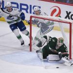 
              Minnesota Wild goalie Cam Talbot, right, stops a shot as Wild defenseman Jared Spurgeon (46) and Vancouver Canucks right wing Vasily Podkolzin, second from left, and right wing Alex Chiasson during the third period of an NHL hockey game Thursday, March 24, 2022, in St. Paul, Minn. The Wild won 3-2 in overtime. (AP Photo/Craig Lassig)
            