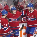 
              Montreal Canadiens' Cole Caufield (22) celebrates with Nick Suzuki (14) and Joel Edmundson (44) after scoring against the Ottawa Senators during the second period of an NHL hockey game Saturday, March 19, 2022, in Montreal. (Graham Hughes/The Canadian Press via AP)
            