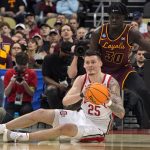 
              Ohio State's Kyle Young (25) looks to pass as Loyola of Chicago's Aher Uguak (30) defends during the first half of a college basketball game in the first round of the NCAA tournament in Pittsburgh, Friday, March 18, 2022. (AP Photo/Gene J. Puskar)
            