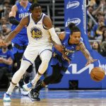
              Golden State Warriors forward Jonathan Kuminga (00) and Orlando Magic guard Markelle Fultz, right, go after a loose ball during the second half of an NBA basketball game, Tuesday, March 22, 2022, in Orlando, Fla. (AP Photo/John Raoux)
            