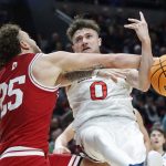 
              St. Mary's guard Logan Johnson (0) is fouled by Indiana forward Race Thompson (25) during the first half of a first-round NCAA college basketball tournament game, Thursday, March 17, 2022, in Portland, Ore. (AP Photo/Craig Mitchelldyer)
            
