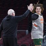 
              Miami forward Thomas Oosterbroek, right, and head coach Jim Larranaga high five during a practice for the NCAA men's college basketball tournament Thursday, March 24, 2022, in Chicago. Miami faces Iowa State in a Sweet 16 game on Friday. (AP Photo/Nam Y. Huh)
            