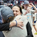 
              FILE - Longwood head coach Rebecca Tillett, right, gets a celebratory hug from a player after an NCAA college basketball game against Campbell for the championship of the Big South Conference tournament Sunday, March 6, 2022, in Charlotte, N.C. The Longwood University men's and women's basketball teams are on the road to making Farmville more than just a sleepy little town in central Virginia known for its massive furniture warehouses. Both the teams are set to make their NCAA Tournament debuts.  (AP Photo/Rusty Jones, File)
            