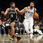 
              Dallas Mavericks guard Spencer Dinwiddie (26) drives against Brooklyn Nets guard Cam Thomas (24) in the first half of an NBA basketball game, Wednesday, March 16, 2022, in New York. (AP Photo/John Minchillo)
            
