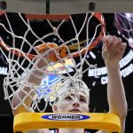 
              Kansas' Christian Braun cuts down the net after a college basketball game in the Elite 8 round of the NCAA tournament Sunday, March 27, 2022, in Chicago. Kansas won 76-50 to advance to the Final Four. (AP Photo/Nam Y. Huh)
            