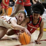 
              Iowa State guard Emily Ryan, left, fights for a loose ball with Georgia guard Chloe Chapman (1) during the second half of a second-round game in the NCAA women's college basketball tournament, Sunday, March 20, 2022, in Ames, Iowa. (AP Photo/Charlie Neibergall)
            