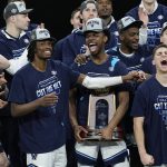 
              Villanova celebrates with the trophy after their win against Houston during a college basketball game in the Elite Eight round of the NCAA tournament on Saturday, March 26, 2022, in San Antonio. (AP Photo/Eric Gay)
            
