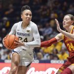
              West Virginia guard Savannah Samuel (24) protects the ball from Iowa State guard Ashley Joens (24) during the first half of an NCAA college basketball game in Morgantown, W.Va., Saturday, March 5, 2022. (AP Photo/William Wotring)
            