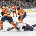 
              Washington Capitals' Nick Jensen (3) hits the ice as Edmonton Oilers' Kailer Yamamoto (56) takes the puck and Connor McDavid (97) looks on during the second period of an NHL hockey game Wednesday, March 9, 2022 in Edmonton, Alberta.(Amber Bracken/The Canadian Press via AP)
            
