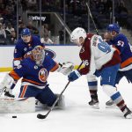 
              New York Islanders goaltender Semyon Varlamov (40) makes a save as teammate center Casey Cizikas (53) defends against Colorado Avalanche right wing Mikko Rantanen (96) during the first period of an NHL hockey game on Monday, March 7, 2022, in Elmont, N.Y. (AP Photo/Jim McIsaac)
            
