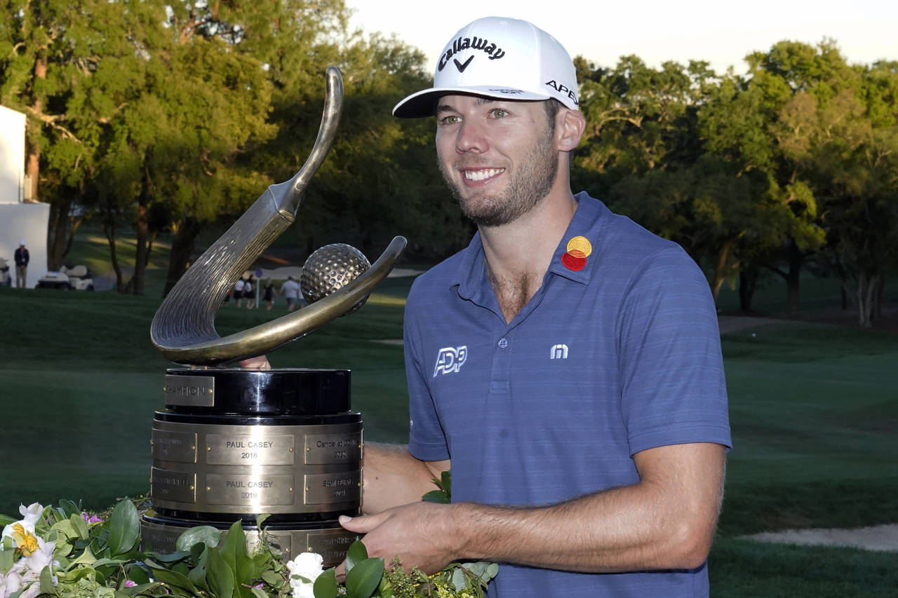 Sam Burns poses with the trophy after winning the Valspar Championship golf tournament Sunday, Marc...