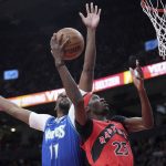 
              Toronto Raptors forward Chris Boucher (25) his his dunk attempt rejected by Minnesota Timberwolves center Naz Reid (11) during the first half of an NBA basketball game Wednesday, March 30, 2022, in Toronto. (Nathan Denette/The Canadian Press via AP)
            