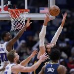
              New Orleans Pelicans center Jonas Valanciunas leaps for a rebound against Sacramento Kings forward Harrison Barnes (40) in the second half of an NBA basketball game in New Orleans, Wednesday, March 2, 2022. The Pelicans won 125-95. (AP Photo/Gerald Herbert)
            