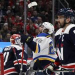 
              St. Louis Blues left wing Nathan Walker (26) celebrates his goal next to Washington Capitals goaltender Vitek Vanecek (41) and left wing Alex Ovechkin (8) during the second period of an NHL hockey game Tuesday, March 22, 2022, in Washington. (AP Photo/Nick Wass)
            