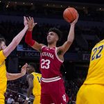 
              Indiana forward Trayce Jackson-Davis (23) shoots over Michigan center Hunter Dickinson (1) in the first half of an NCAA college basketball game at the Big Ten Conference tournament in Indianapolis, Thursday, March 10, 2022. (AP Photo/Michael Conroy)
            