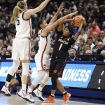 
              Connecticut's Paige Bueckers, left, and Azzi Fudd, center, pressure Mercer's Amoria Neal-Tysor  during the first half of a first-round women's college basketball game in the NCAA tournament, Saturday, March 19, 2022, in Storrs, Conn. (AP Photo/Jessica Hill)
            