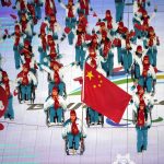 
              Guo Yujie and Wang Zhidong carry the flag of China as they make their entrance during the opening ceremony at the 2022 Winter Paralympics, Friday, March 4, 2022, in Beijing. (AP Photo/Dita Alangkara)
            