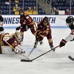 
              Minnesota-Duluth goalie Emma Soderberg (30) and Naomi Rogge (9) block a shot on goal by Ohio State's Clair DeGeorge (14) during the first period of the NCAA Frozen Four championship hockey game, Sunday, March 20, 2022, in State College, Pa. (AP Photo/Gary M. Baranec)
            