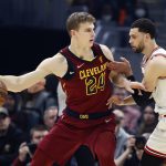 
              Cleveland Cavaliers' Lauri Markkanen (24) is defended by Chicago Bulls' Zach LaVine (8) during the first half of an NBA basketball game Saturday, March 26, 2022, in Cleveland. (AP Photo/Ron Schwane)
            