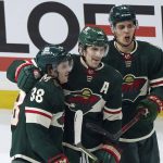 
              From left to right, Minnesota Wild's Ryan Hartman, Marcus Foligno and Joel Ericsson Ek celebrate Hartman's empty-net goal in the third period of an NHL hockey game against the Vegas Golden Knights, Monday, March 21, 2022, in St. Paul, Minn. (AP Photo/Jim Mone)
            