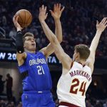 
              Orlando Magic's Moritz Wagner (21) shoots against Cleveland Cavaliers' Lauri Markkanen (24) during the first half of an NBA basketball game, Monday, March 28, 2022, in Cleveland. (AP Photo/Ron Schwane)
            