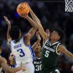 
              Michigan State guard Max Christie blocks a shot by Duke guard Jeremy Roach during the second half of a college basketball game in the second round of the NCAA tournament on Sunday, March 20, 2022, in Greenville, S.C. (AP Photo/Chris Carlson)
            