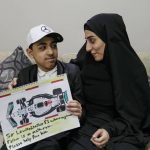 
              Ahmed, 12 years old, son of Mohammed Ramadhan, a former member of Bahrain's security forces who is facing the death penalty in Bahrain, holds a drawing he made of F1 driver Lewis Hamilton's Formula One car, as he poses for a photograph with his mother Zainab Ebrahim in Manama, Bahrain, Thursday, March 17, 2022. Ahead of Sunday's season-opening F1 race in Bahrain, Ahmed proudly held up the drawing of Hamilton's famed No. 44 Mercedes car along with his own words of hope: "Sir Lewis, another F1 where my innocent father is on death row. Please help free him." (AP Photo)
            