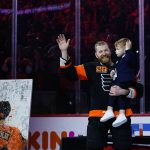 
              Philadelphia Flyers' Claude Giroux, left, and his son, Gavin wave during a ceremony honoring Giroux's 1000th game as a Flyer before an NHL hockey game against the Nashville Predators, Thursday, March 17, 2022, in Philadelphia. (AP Photo/Matt Slocum)
            