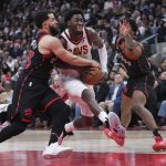
              Cleveland Cavaliers guard Caris LeVert (3) tries to drive past Toronto Raptors guard Fred VanVleet (23) and Raptors guard Armoni Brooks (1) during the second half of an NBA basketball game Thursday, March 24, 2022, in Toronto. (Nathan Denette/The Canadian Press via AP)
            
