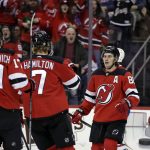
              New Jersey Devils center Jack Hughes (86) celebrates with teammates after scoring a goal during the first period of an NHL hockey game against the Montreal Canadiens on Sunday, March 27, 2022, in Newark, N.J. (AP Photo/Adam Hunger)
            