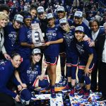 
              Connecticut players hold up the East Region championship trophy after defeating NC State in the East Regional final college basketball game of the NCAA women's tournament, Monday, March 28, 2022, in Bridgeport, Conn. (AP Photo/Frank Franklin II)
            