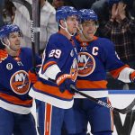 
              New York Islanders left wing Anders Lee (27) celebrates with teammate centers Brock Nelson (29) and Jean-Gabriel Pageau (44) after his goal against the Colorado Avalanche during the first period of an NHL hockey game on Monday, March 7, 2022, in Elmont, N.Y. (AP Photo/Jim McIsaac)
            