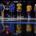 
              UCLA players stretch during practice for the NCAA men's college basketball tournament, Thursday, March 24, 2022, in Philadelphia. (AP Photo/Matt Rourke)
            