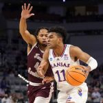 
              Kansas guard Remy Martin (11) works to the basket against Texas Southern guard Bryson Etienne (4) in the first half of a first-round game in the NCAA college basketball tournament in Fort Worth, Texas, Thursday, March 17, 2022. (AP Photo/Tony Gutierrez)
            
