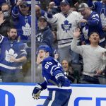 
              Fans cheer on Toronto Maple Leafs right wing Ilya Mikheyev (65) after his shorthanded goal against the Winnipeg Jets during the second period of an NHL hockey game Thursday, March 31, 2022, in Toronto. (Frank Gunn/The Canadian Press via AP)
            