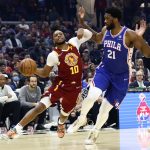 
              Cleveland Cavaliers' Darius Garland (10) drives against Philadelphia 76ers' Joel Embiid (21) during the first half of an NBA basketball game Wednesday, March 16, 2022, in Cleveland. (AP Photo/Ron Schwane)
            