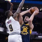 
              Indiana Pacers center Goga Bitadze (88) shoots over Denver Nuggets guard Davon Reed (9) during the second half of an NBA basketball game in Indianapolis, Wednesday, March 30, 2022. The Nuggets won 125-118. (AP Photo/Michael Conroy)
            