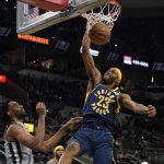 
              Indiana Pacers' Isaiah Jackson (23) dunks against San Antonio Spurs' Keita Bates-Diop during the first half of an NBA basketball game in San Antonio, Saturday, March 12, 2022. (AP Photo/Chuck Burton)
            