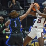 
              South Carolina's Laeticia Amihere (15) protects the ball from Kentucky's Robyn Benton (1) in the first half of the NCAA women's college basketball Southeastern Conference tournament championship game Sunday, March 6, 2022, in Nashville, Tenn. (AP Photo/Mark Humphrey)
            
