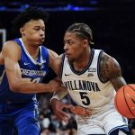 
              Creighton's Trey Alexander, left, defends against Villanova's Justin Moore (5) during the first half of an NCAA college basketball game in the final of the Big East conference tournament Saturday, March 12, 2022, in New York. (AP Photo/Frank Franklin II)
            