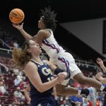 
              Kansas guard Aniya Thomas, top, drives to the basket against Georgia Tech forward Lorela Cubaj, left, during the first half of a first-round game in the NCAA women's college basketball tournament Friday, March 18, 2022, in Stanford, Calif. (AP Photo/Tony Avelar)
            