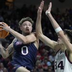 
              Saint Mary's Logan Johnson (0) shoots against Gonzaga's Chet Holmgren (34) during the second half of an NCAA college basketball championship game at the West Coast Conference tournament Tuesday, March 8, 2022, in Las Vegas. (AP Photo/John Locher)
            