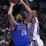 
              Dallas Mavericks guard Spencer Dinwiddie (26) goes up for a shot as Sacramento Kings guard Davion Mitchell (15) defends in the first half of an NBA basketball game in Dallas, Saturday, March, 5, 2022. (AP Photo/Tony Gutierrez)
            
