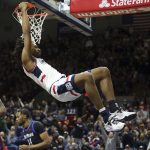 
              Connecticut's Isaiah Whaley (5) slam dunks the ball during the first half of an NCAA college basketball game against DePaul Saturday, March 5, 2022, in Storrs, Conn. (AP Photo/Stew Milne)
            